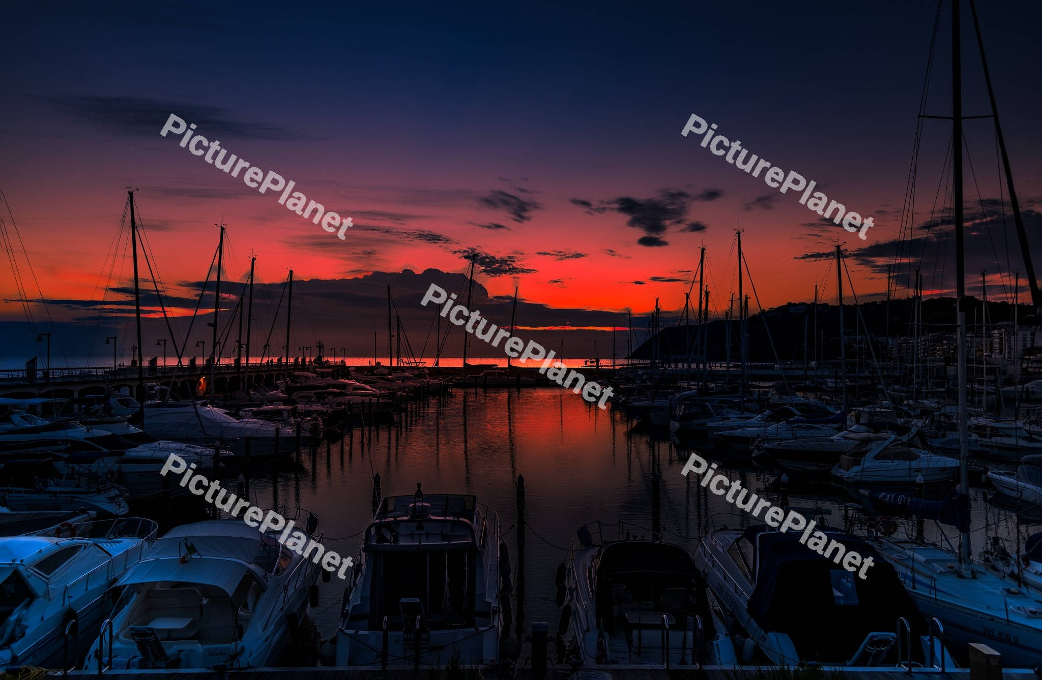 Yacht marina in the sea at sunset